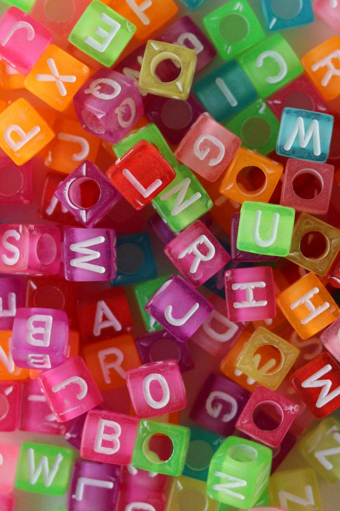 Vibrant multicolored letter beads for crafting and educational play.